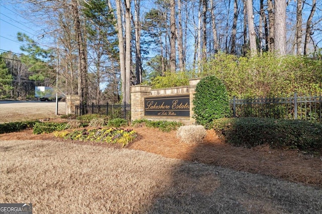 community / neighborhood sign with fence