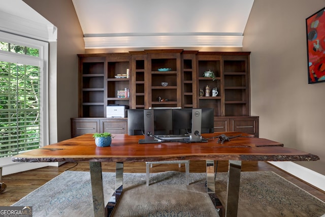 office space featuring ornamental molding, baseboards, and wood finished floors