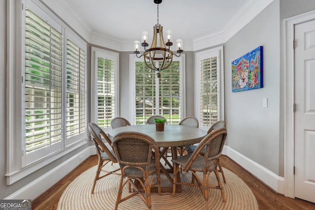 dining room featuring a chandelier, wood finished floors, and ornamental molding