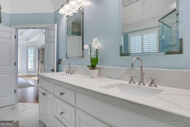 full bathroom featuring crown molding, double vanity, marble finish floor, and a sink