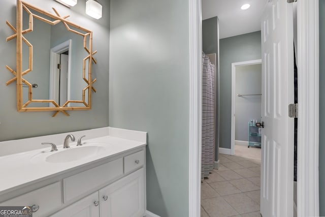 full bathroom featuring tile patterned flooring, vanity, and baseboards