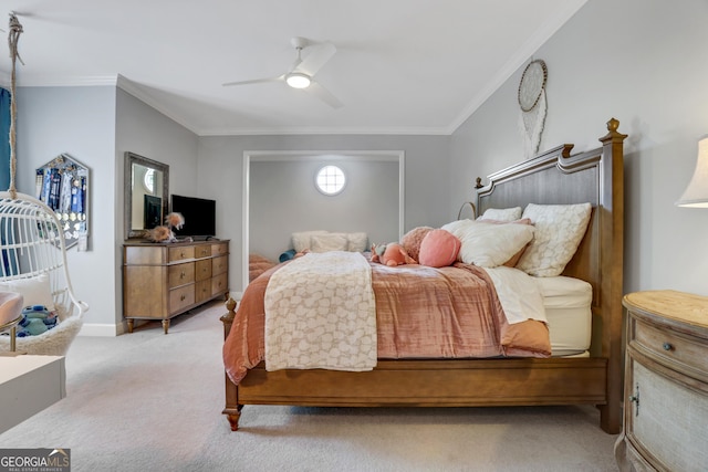 bedroom featuring light carpet, ceiling fan, baseboards, and ornamental molding