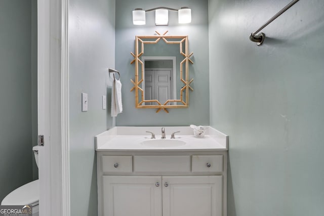 bathroom featuring toilet and vanity