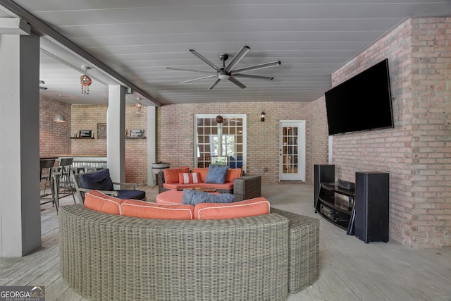 exterior space with a wooden deck, ceiling fan, and outdoor lounge area