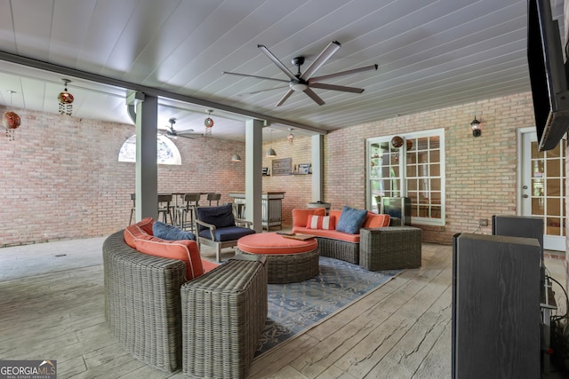 wooden terrace with outdoor lounge area and a ceiling fan