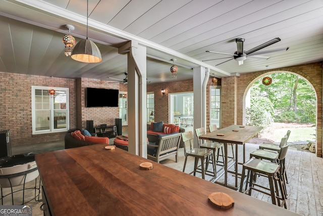 view of patio / terrace featuring an outdoor living space, outdoor dining area, and ceiling fan