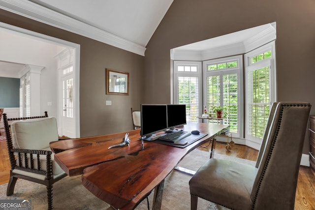 office featuring high vaulted ceiling, wood finished floors, crown molding, and ornate columns