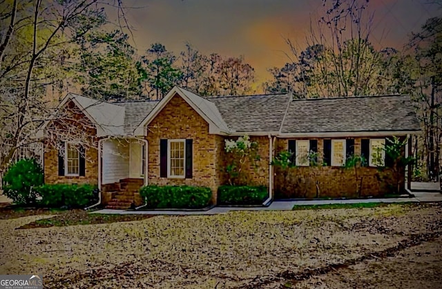 ranch-style home featuring brick siding