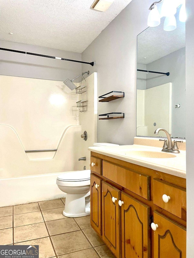 bathroom featuring vanity, a textured ceiling, shower / bath combination, tile patterned floors, and toilet