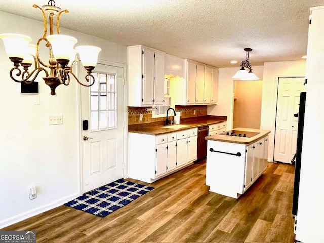 kitchen with a sink, stainless steel dishwasher, dark wood-style flooring, and white cabinetry