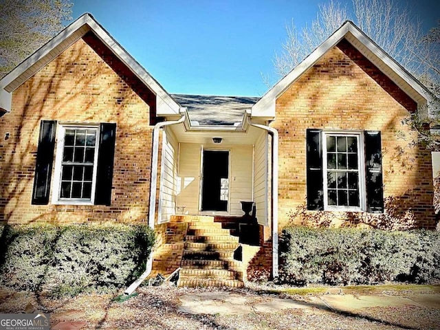 entrance to property featuring brick siding