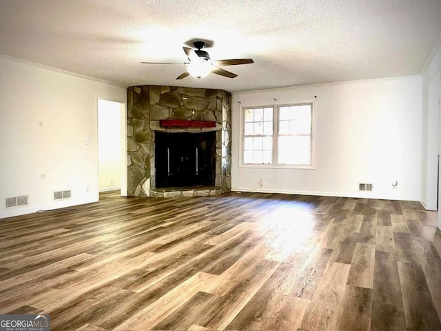 unfurnished living room featuring visible vents and wood finished floors