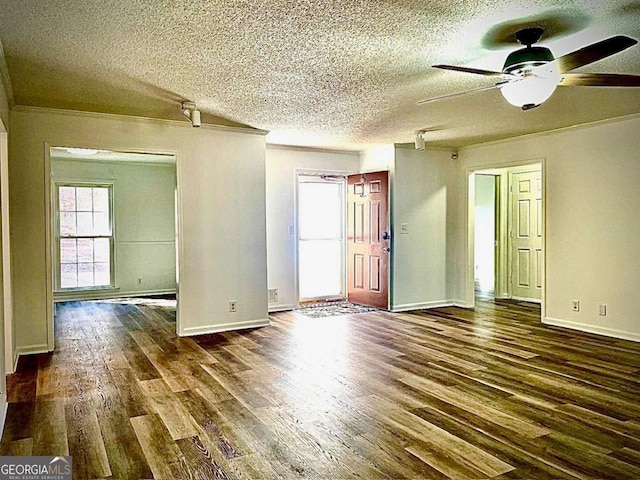 empty room featuring wood finished floors, baseboards, and a textured ceiling