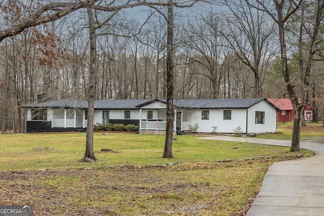 ranch-style home featuring covered porch, a front yard, and driveway