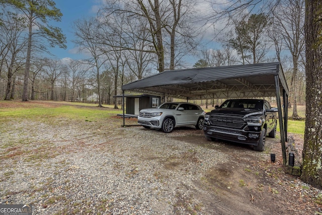 view of car parking featuring a detached carport and dirt driveway