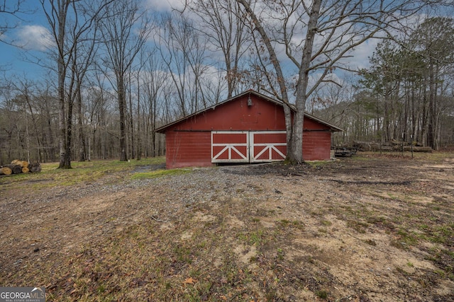 view of barn with a view of trees