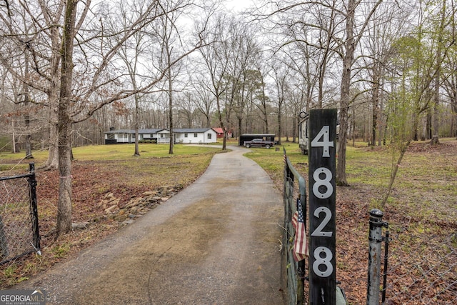 view of street featuring driveway and a gated entry