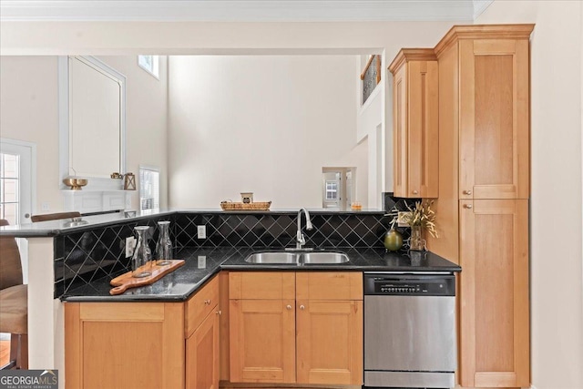 kitchen with a sink, stainless steel dishwasher, a peninsula, crown molding, and decorative backsplash