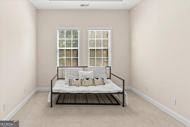 living area with visible vents, baseboards, and carpet flooring