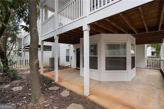 view of patio featuring central AC unit and fence