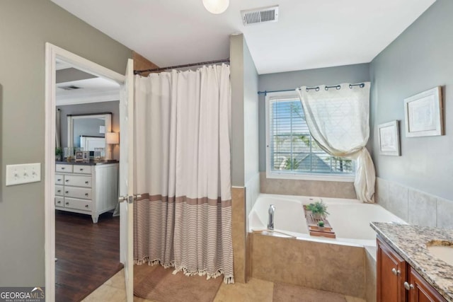 full bath featuring visible vents, a garden tub, a shower with curtain, wood finished floors, and vanity