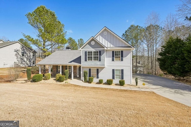 view of front of home with a front lawn, board and batten siding, and driveway