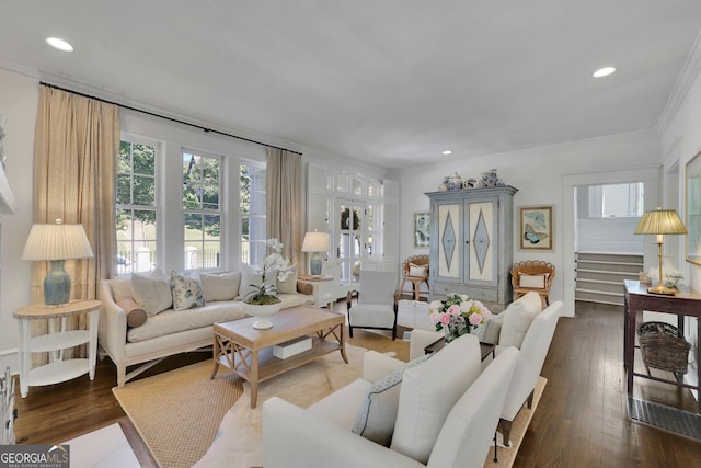 living area with stairway, a healthy amount of sunlight, crown molding, and wood-type flooring