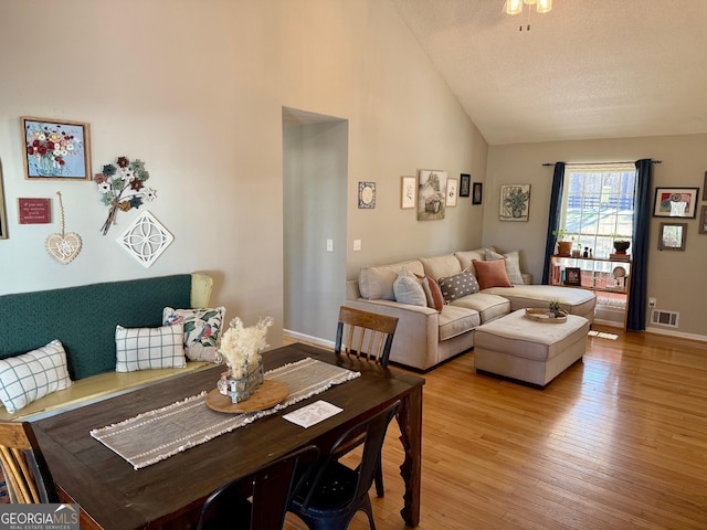 interior space featuring a textured ceiling, baseboards, visible vents, and light wood-type flooring