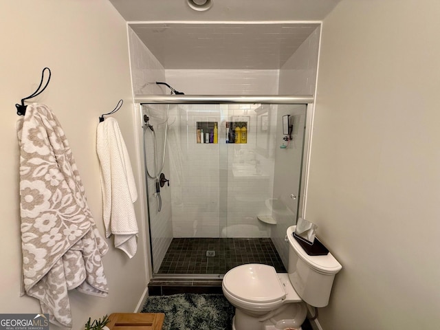 full bathroom with toilet and a stall shower