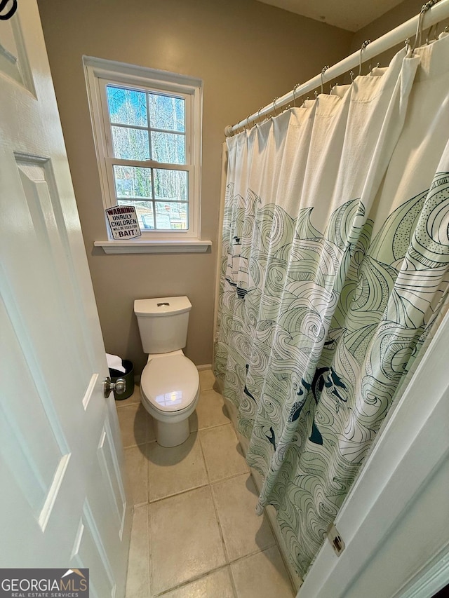 full bath with tile patterned floors, curtained shower, and toilet