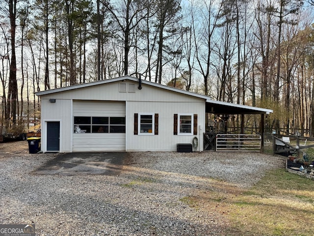 garage with gravel driveway