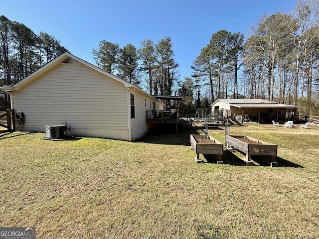 view of property exterior with a garden, cooling unit, a lawn, and a wooden deck