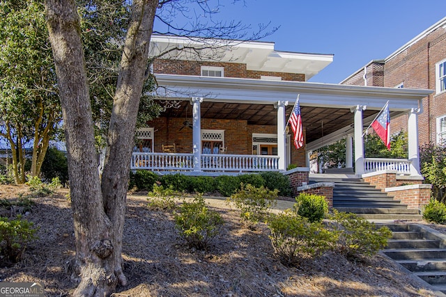 view of front of property with brick siding and covered porch