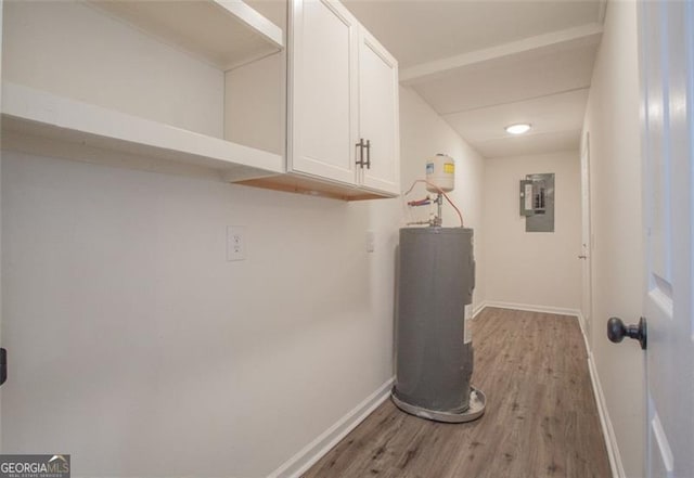 utility room featuring water heater and electric panel