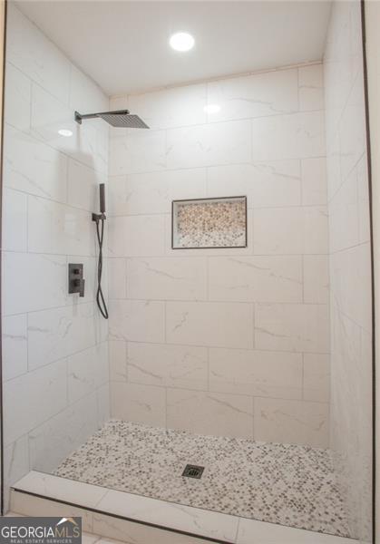 bathroom with a tile shower