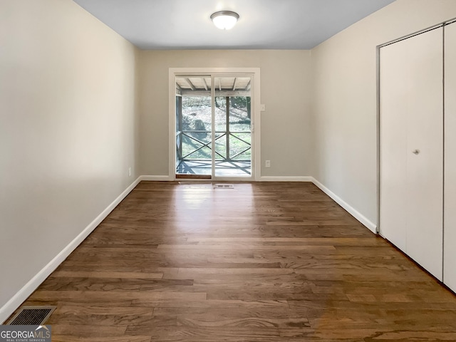 unfurnished dining area featuring visible vents, baseboards, and wood finished floors