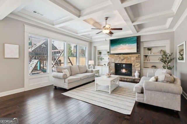 living room with dark wood finished floors, visible vents, a stone fireplace, and built in features