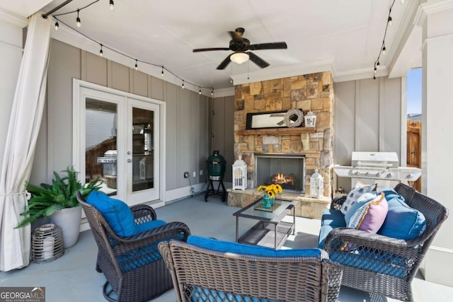 view of patio / terrace with grilling area, a ceiling fan, and an outdoor living space with a fireplace