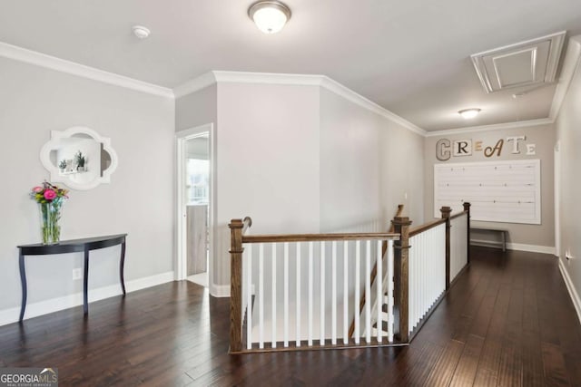 corridor with an upstairs landing, attic access, and hardwood / wood-style flooring