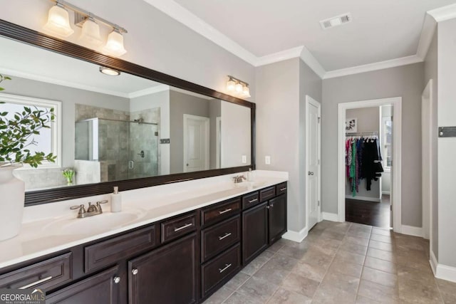 full bath with visible vents, a stall shower, ornamental molding, a sink, and a spacious closet