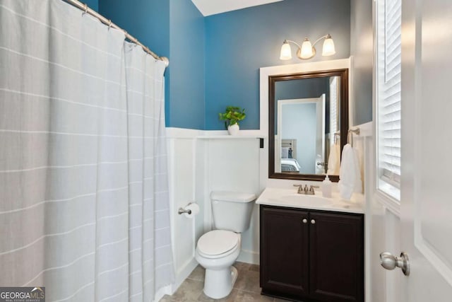 bathroom with vanity, tile patterned floors, curtained shower, and toilet