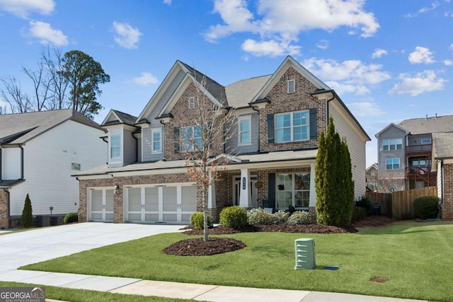 view of front of house with brick siding, driveway, a garage, and fence