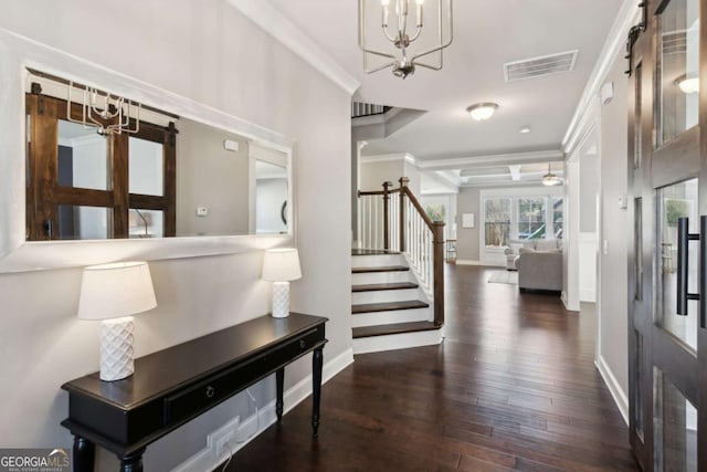 entrance foyer with visible vents, ornamental molding, wood finished floors, stairway, and baseboards