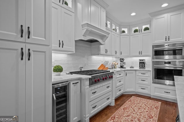 kitchen with white cabinetry, wine cooler, backsplash, and stainless steel appliances