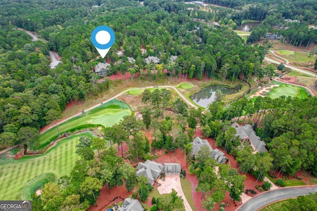 drone / aerial view featuring view of golf course and a water view