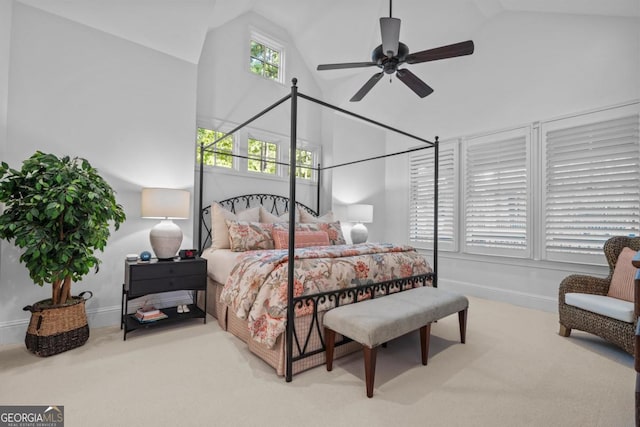 carpeted bedroom with ceiling fan, high vaulted ceiling, and baseboards