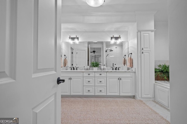 full bath featuring double vanity, a stall shower, ornamental molding, and a sink