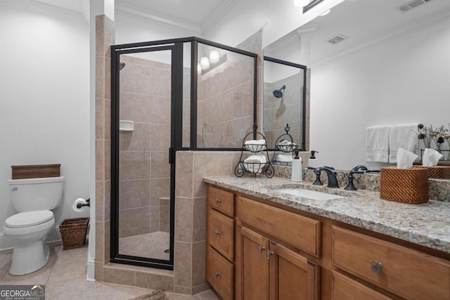 bathroom featuring vanity, a stall shower, crown molding, toilet, and tile patterned floors