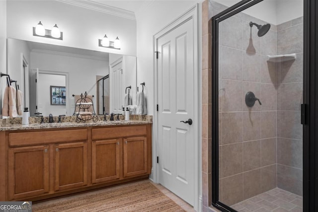 full bathroom featuring double vanity, a sink, a shower stall, and ornamental molding