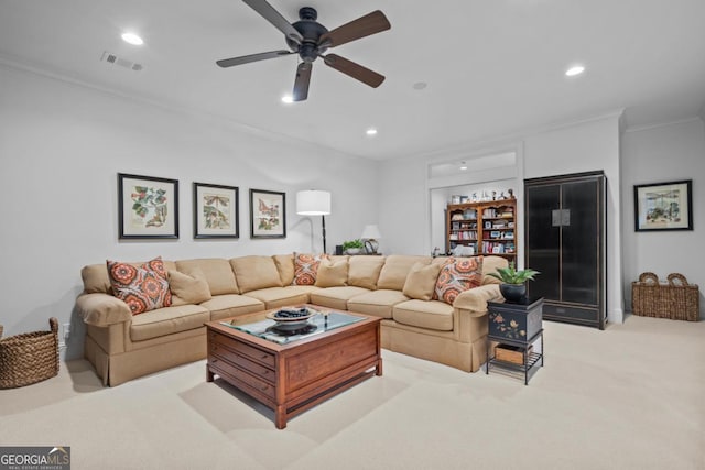 living area with recessed lighting, visible vents, light carpet, and crown molding